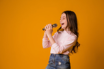 baby girl with microphone smiling singing,Fat girl singing song into microphone. Young star, looking for talents.