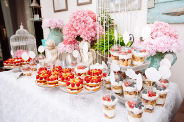 Buffet with sweets. Cakes with raspberries. Sweet table for banquets, weddings, parties.