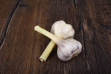 Garlic bulbs of a new crop on a wooden background.