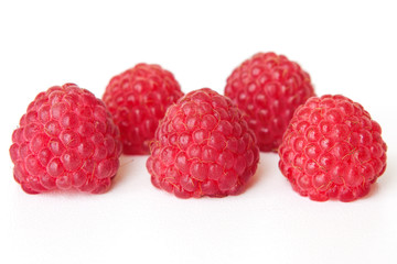 fresh juicy red raspberries on white background