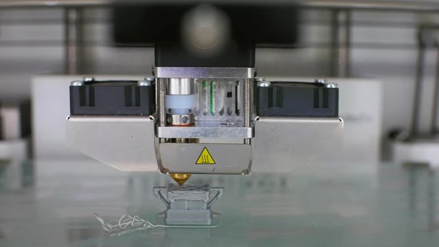 Modern 3D printer printing an object from the hot molten