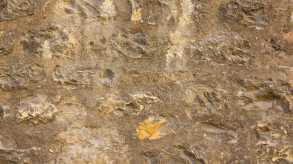 Background of old stone wall. The texture of the stone surface. Brickwork in the old European city. Pattern in retro style