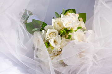 wedding bouquet of white flowers: freesia, phalaenopsis orchids and roses