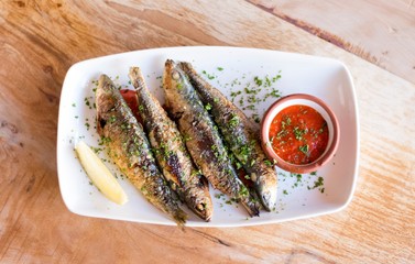 Sardines on a  plate with romesco salsa 1