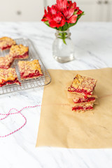 Freshly Baked Strawberry Bar Cookies, Some Cooling on Wire Rack with some isolated in front on white countertop