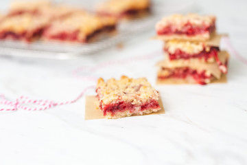 Freshly Baked Strawberry Bar Cookies, Some Cooling on Wire Rack with some isolated in front on white countertop