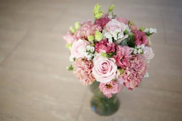 Delicate wedding bouquet in pink tones of roses and lisianthus.