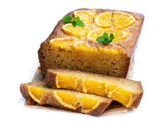 Homemade orange syrup cake on white wooden table