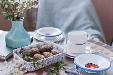 Traditional Russian cake with cocoa and chocolate in the shape of a ball. Served breakfast table. Cozy atmosphere at home.