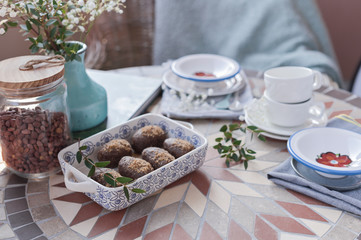 Traditional Russian cake with cocoa in the shape of a ball. Served breakfast table with mugs of tea and dessert.