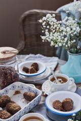 Traditional Russian cake with cocoa and chocolate in the shape of a ball. Served breakfast table. Cozy atmosphere at home.