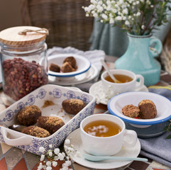 Traditional Russian cake with cocoa in the shape of a ball. Served breakfast table with mugs of tea and dessert.