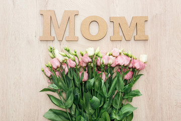 top view of eustoma flowers with wooden mom word on table