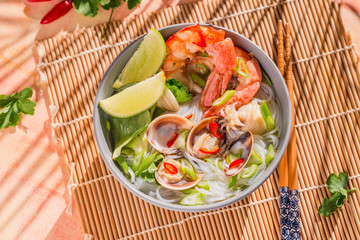 Rice noodles bowl with seafood, asian spicy bowl.