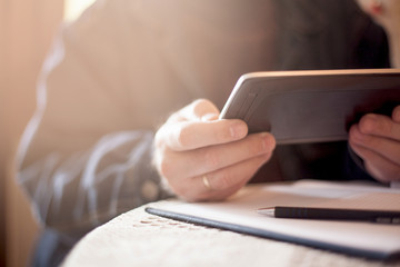 Digital tablet in hand.