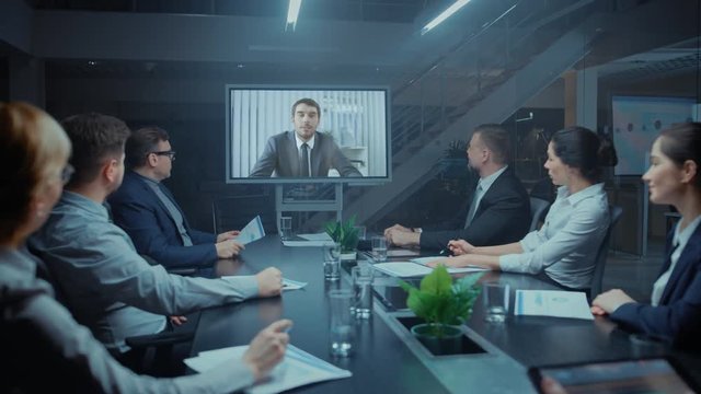 In the Conference Room Group of Directors, Investors and Businessmen Making Late Night Video Conference Call To Talk with International Corporation Representative