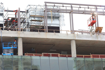 the image of welder and worker at construction zone