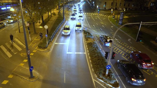Hungary. City of Budapest. Night. Car traffic along the city street. View from above. Fixed Camera
