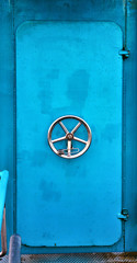 A light blue old ship door on the Baltic Sea.