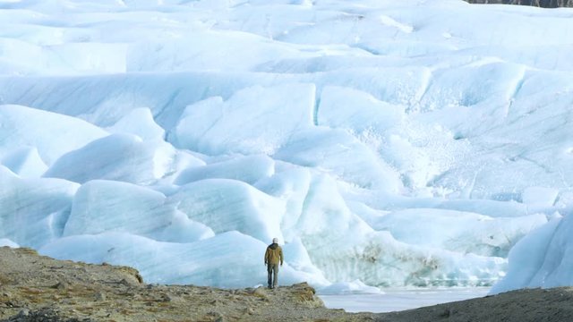 Epic Shot Man and Powerful Glacier, Iceland in Winter.