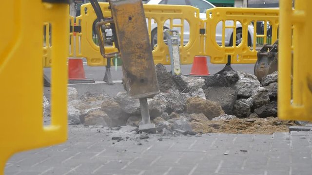A machine drilling the road.