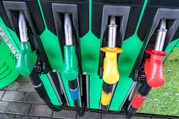 Gas and petrol station. Guns for refueling at a gas station. Detail of a petrol pump different colors in gas station. Close up on fuel nozzle in oil dispenser with gasoline and diesel
