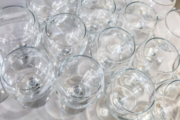 lot of blurred empty glasses on reception party table