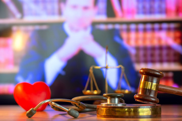 Justice Gavel and stethoscope with red heart on background.law concept Judge law medical Pharmacy compliance Health care business rules. 