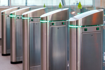 Close up of modern turnstiles for the passage of subway trains transport/ railway station, inside. Entrance in metro with electronic card access.