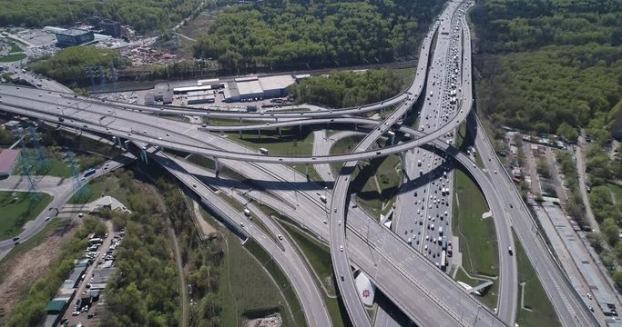 Aerial top view of road junction and  transport traffic with vehicle movement by drone. Drone video of Moscow  junction road at day time. Dmitrovskoe shosse, Russia.