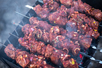 roasted meat, skewers with onions on skewers on the grill