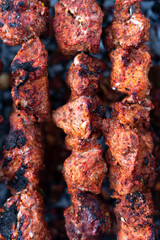 roasted meat, skewers with onions on skewers on the grill