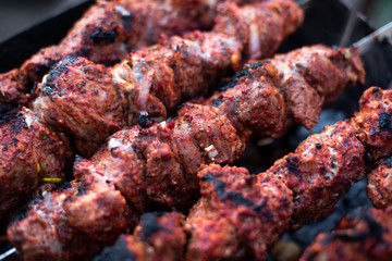 roasted meat, skewers with onions on skewers on the grill