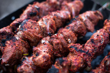 roasted meat, skewers with onions on skewers on the grill