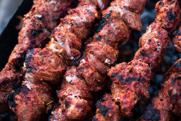 roasted meat, skewers with onions on skewers on the grill