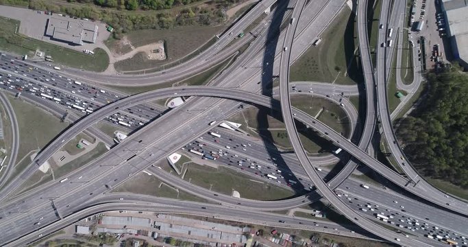 Aerial top view of road junction and  transport traffic with vehicle movement by drone. Drone video of Moscow  junction road at day time. Dmitrovskoe shosse, Russia.