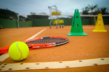 tennis ball and racket on a court