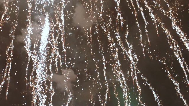 Showering Sparks and Explosions From Fireworks TILT UP SLOW MOTION
