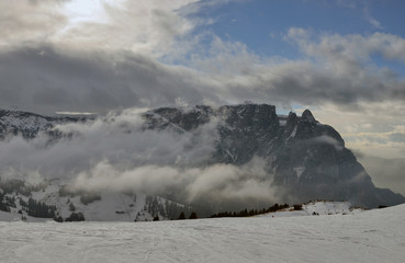 Winter panorama of italian ski resort with background of Seiser Alm, Alpe di Siusi, a high altitude alpine meadow in Dolomites with Langkofel and Plattkofel mountains under snow, South Tyrol, Italy.