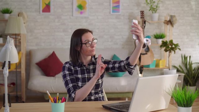 Young woman with a scar from a burn on her face takes a selfie