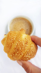 fresh croissants with natural sunlight on plate traditional french breakfast with coffee 