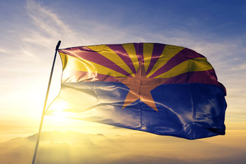 Arizona state of United States flag waving on the top sunrise mist fog