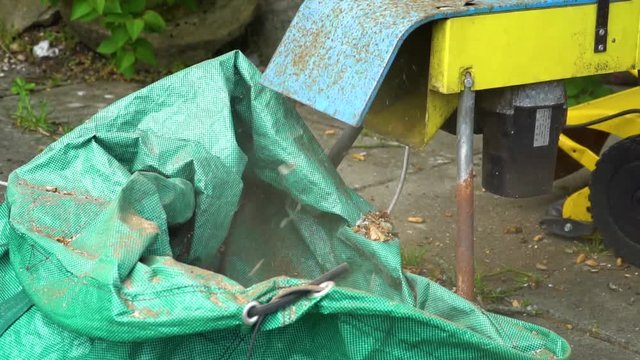 Vintage wood chipper chopping wood in slow motion.