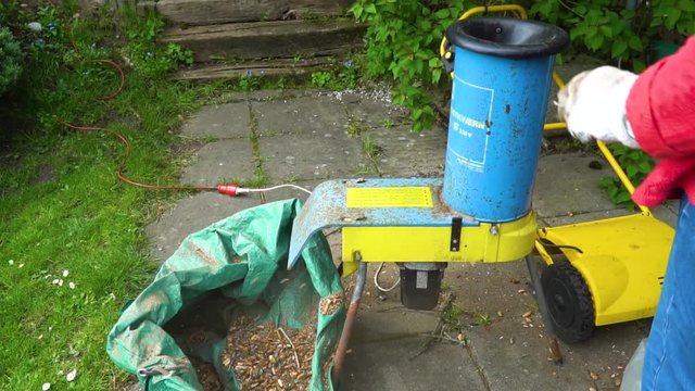Vintage wood chipper chopping wood in slow motion.
