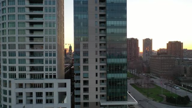 Slow panning drone shot, close to the buildings of Downtown Milwaukee during sunset