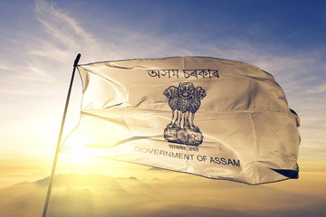 Assam state of India flag waving on the top sunrise mist fog