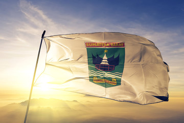 West Sumatra province of Indonesia flag waving on the top sunrise mist fog