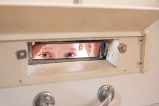 Girl Looking Through The Letter Box