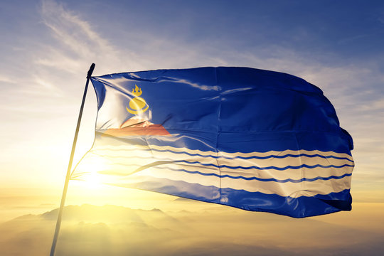 Uvs province of Mongolia flag waving on the top sunrise mist fog