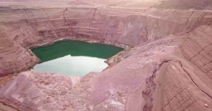Hidden lost spring lake in desert negev of Israel Agam timna. Aerial shoot above desert Oasis at Timna, Orange Red cliff brown mountain rocks in the middle of the Arava Edom mountains,